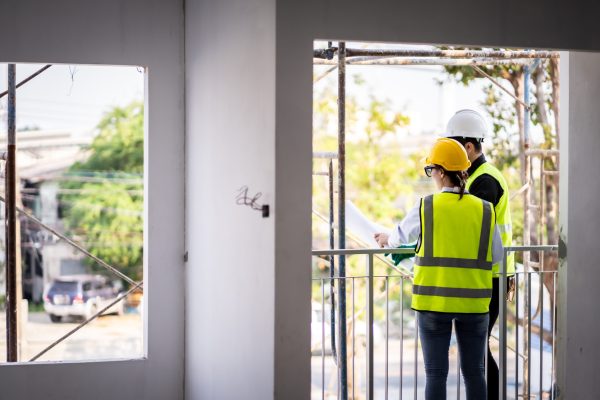 Engineer technician inspects building structure Engineer technicians are looking at and analyzing unfinished construction projects. In order to be in accordance with the design